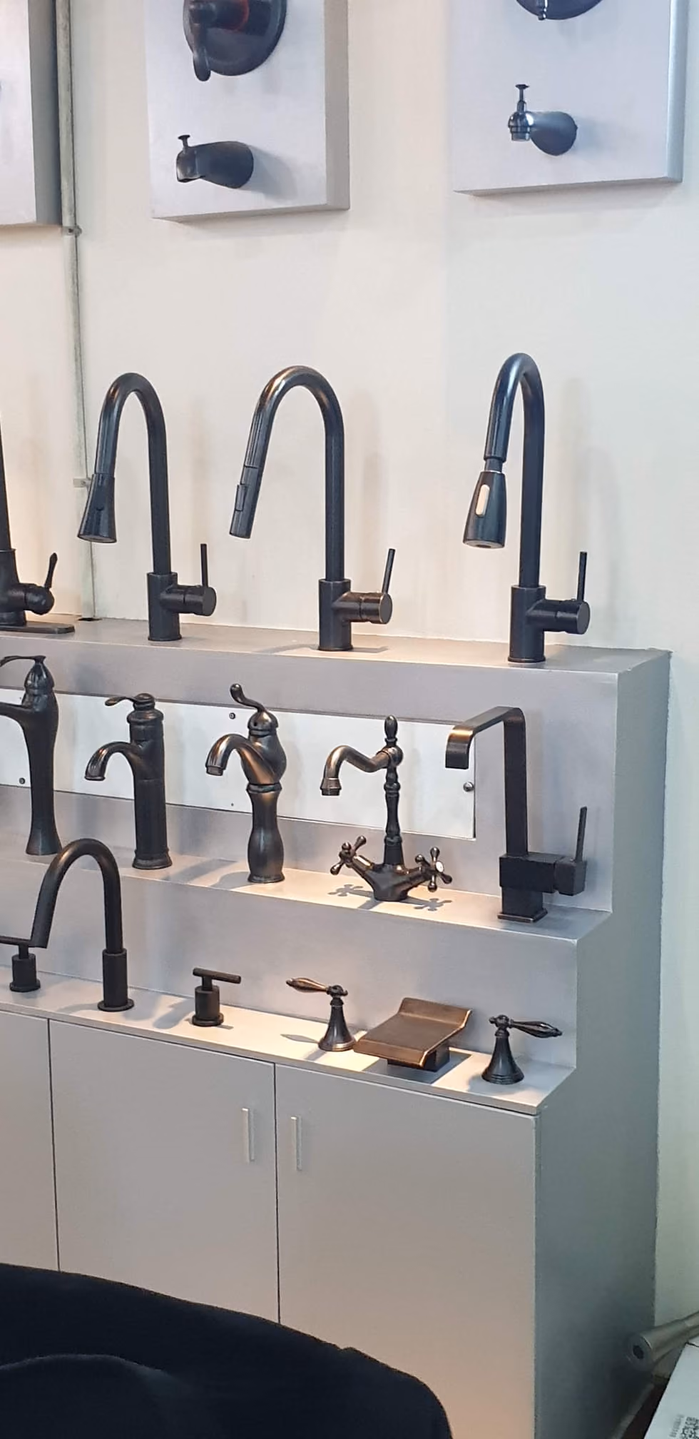 A wall of kitchen and bath faucets in the DiHub showroom